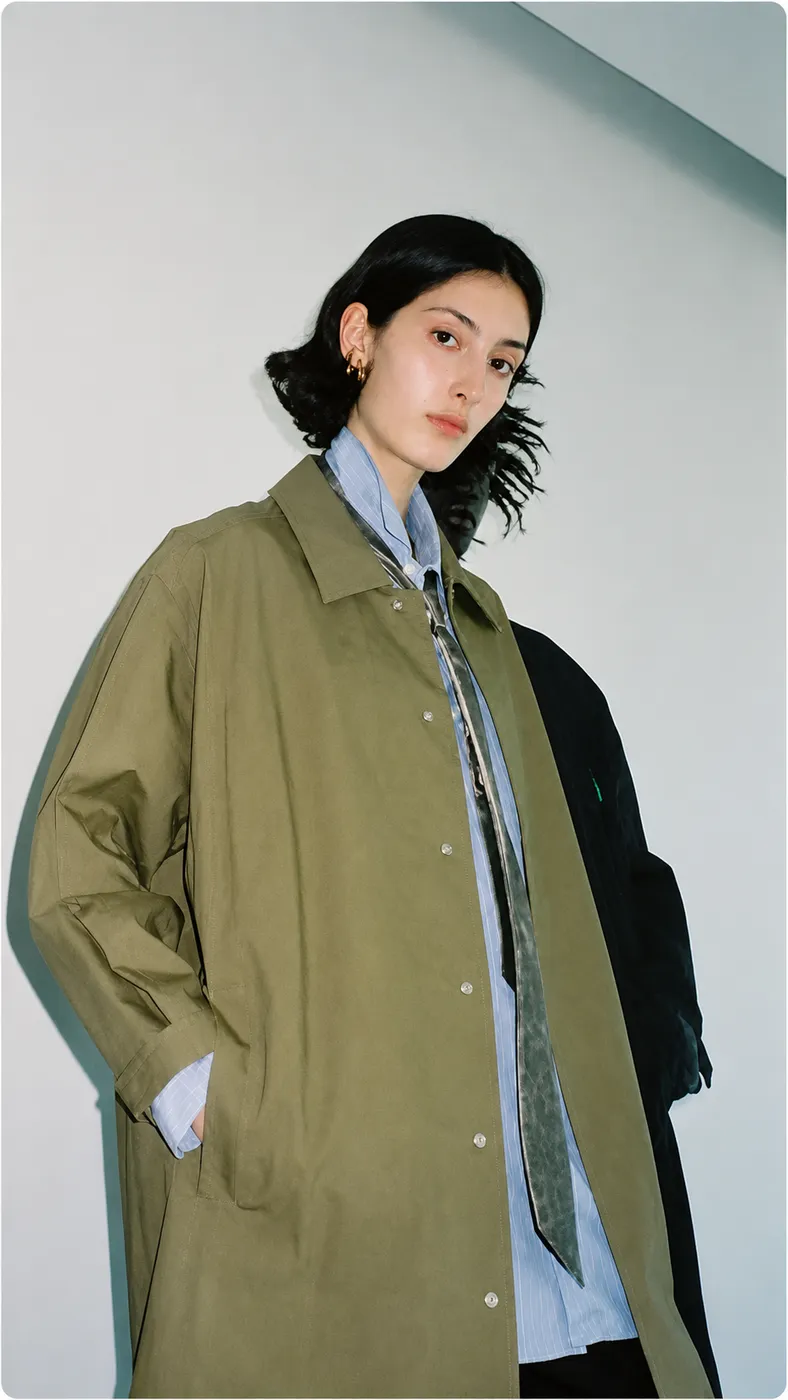 Model in an oversized olive overcoat